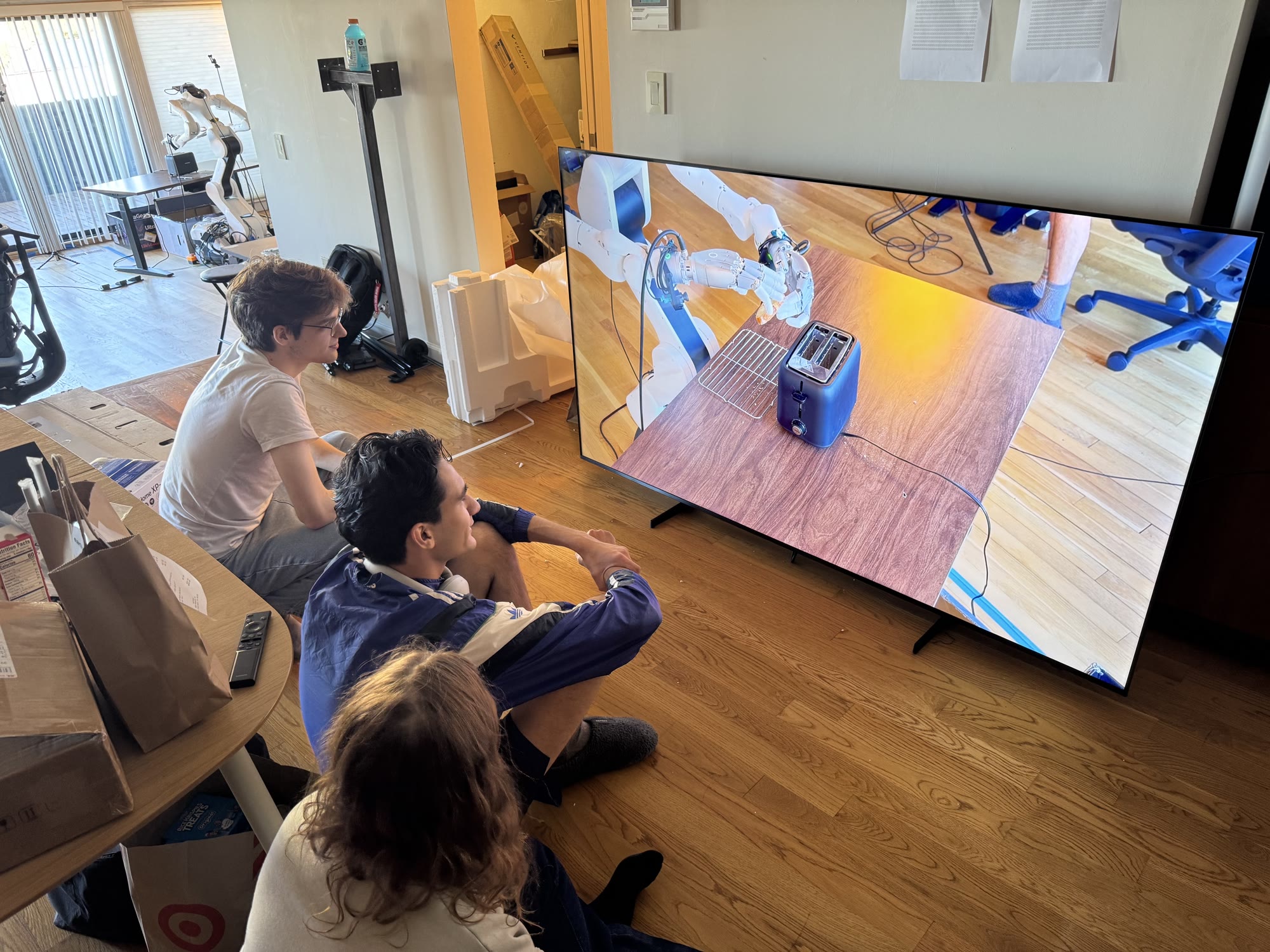 The Markov Robotics team watching a robot make toast
